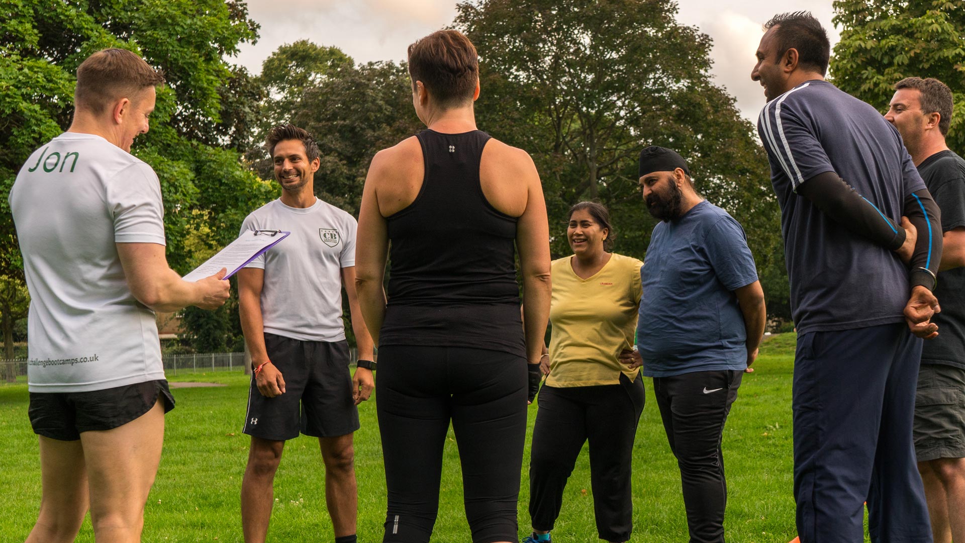 Challenge Bootcamp members laughing together after an outdoor session